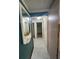 The hallway features neutral walls and flooring with a framed mirror accent at 14935 Ogden Loop, Odessa, FL 33556