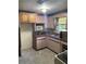 The kitchen has tile flooring, a corner sink, and a microwave at 14935 Ogden Loop, Odessa, FL 33556