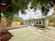 Spacious backyard featuring a concrete patio, a privacy fence, and mature landscaping at 1554 Elmwood St, Clearwater, FL 33755
