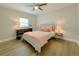 Bedroom featuring a window, bedside table and a bed with pink sheets and pillows at 1554 Elmwood St, Clearwater, FL 33755