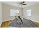 Cozy bedroom with wood laminate floors, ceiling fan, and a large area rug at 1554 Elmwood St, Clearwater, FL 33755