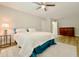 Bedroom features a ceiling fan, bedside table and lamp, dresser and laminate wood flooring at 1554 Elmwood St, Clearwater, FL 33755