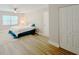 Bedroom featuring a window, bedside table and a bed with a blue bedspread at 1554 Elmwood St, Clearwater, FL 33755