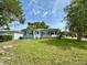 Charming single-story home with a well-maintained lawn, fresh exterior paint, and inviting curb appeal at 1554 Elmwood St, Clearwater, FL 33755