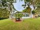 Inviting home featuring new landscaping, fresh exterior paint, mature trees and charming curb appeal at 1554 Elmwood St, Clearwater, FL 33755