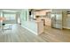 Bright, open kitchen with white cabinets, stainless steel appliances, and island with breakfast bar at 1554 Elmwood St, Clearwater, FL 33755