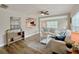 Inviting living room features new wood-look flooring, a ceiling fan, fresh paint and lots of natural light at 1554 Elmwood St, Clearwater, FL 33755