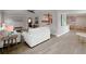 Open-concept living space with new wood-look floors, neutral paint, and a seamless flow into the kitchen at 1554 Elmwood St, Clearwater, FL 33755