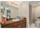 Functional bathroom featuring a wood vanity, ample counter space, and a shower-tub combination at 15612 Farnsworth Ln, Tampa, FL 33624