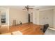 Bright bedroom with hardwood floors, a ceiling fan, and access to an en-suite bathroom at 15612 Farnsworth Ln, Tampa, FL 33624