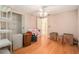 Bedroom with laminate flooring and a ceiling fan, offering ample storage with built-in shelving and closet space at 15612 Farnsworth Ln, Tampa, FL 33624