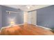 This primary bedroom has natural light, hardwood floors, and a ceiling fan at 15612 Farnsworth Ln, Tampa, FL 33624
