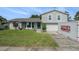 Charming two-story home with a well-maintained lawn and a brick accent wall, featuring a PODS moving container in the driveway at 15612 Farnsworth Ln, Tampa, FL 33624