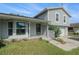 Charming two-story home with a well-maintained lawn and a brick accent wall, complemented by lush greenery at 15612 Farnsworth Ln, Tampa, FL 33624
