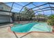 This screened in pool has beautiful trees surrounding for added privacy at 15612 Farnsworth Ln, Tampa, FL 33624