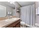 This bathroom has a shower/tub combo, toilet, and a vanity with tan countertop at 1604 Acadia Harbor Pl, Brandon, FL 33511