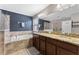 A luxurious bathroom featuring a soaking tub, glass shower, and dual vanities with granite countertops at 1604 Acadia Harbor Pl, Brandon, FL 33511