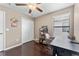 A simple bedroom with a desk, chair, ceiling fan, and closet at 1604 Acadia Harbor Pl, Brandon, FL 33511