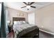 This bedroom has a wooden framed bed, dark wood floors, a ceiling fan, and a closet at 1604 Acadia Harbor Pl, Brandon, FL 33511