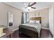 This bedroom has a wooden framed bed, dark wood floors, a ceiling fan, and a closet at 1604 Acadia Harbor Pl, Brandon, FL 33511