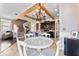 Bright dining area with farmhouse chandelier, wood beam ceiling, and adjacent to the modern kitchen at 1604 Acadia Harbor Pl, Brandon, FL 33511