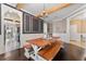 Open dining room with hardwood floors, wood beams, chandelier, and a large wooden table at 1604 Acadia Harbor Pl, Brandon, FL 33511