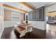 Elegant dining room featuring exposed beams, a farmhouse table with benches, and modern wainscoting at 1604 Acadia Harbor Pl, Brandon, FL 33511