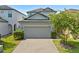 Charming two-story home with a two-car garage, brick driveway, and well-maintained landscaping at 1604 Acadia Harbor Pl, Brandon, FL 33511