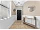 Inviting foyer with tile flooring, decorative mirror, and a view of the home's interior at 1604 Acadia Harbor Pl, Brandon, FL 33511