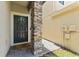 Stylish front door with stone column and a wreath, creating a welcoming entrance at 1604 Acadia Harbor Pl, Brandon, FL 33511