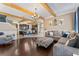 Open concept living room flows to the kitchen, features hardwood floors and exposed wood beams at 1604 Acadia Harbor Pl, Brandon, FL 33511