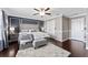 Main bedroom features dark accent wall, hardwood floors, ceiling fan and plenty of natural light at 1604 Acadia Harbor Pl, Brandon, FL 33511