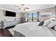 Inviting main bedroom featuring dark hardwood flooring, neutral paint tones, and a large window at 1604 Acadia Harbor Pl, Brandon, FL 33511