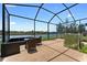 Entertain friends on this screened patio featuring an outdoor lounge set and tranquil waterfront views at 1604 Acadia Harbor Pl, Brandon, FL 33511