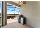 Enjoy outdoor living on this screened patio featuring a grill, mini fridge, and peaceful water views at 1604 Acadia Harbor Pl, Brandon, FL 33511