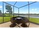 Screened patio with outdoor seating offers a relaxing space with views of the serene lake at 1604 Acadia Harbor Pl, Brandon, FL 33511
