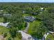 Aerial perspective showcasing the vast neighborhood filled with mature trees and lush landscaping at 1681 Long Bow Ln, Clearwater, FL 33764