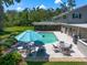 Expansive backyard with pool, patio, and lush lawn, provides ample space for outdoor entertaining and activities at 1681 Long Bow Ln, Clearwater, FL 33764