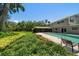 The backyard showcases a refreshing pool and well-maintained landscaping, perfect for outdoor enjoyment and relaxation at 1681 Long Bow Ln, Clearwater, FL 33764