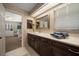 Stylish bathroom with a large mirror, vanity, and an adjoining bedroom at 1681 Long Bow Ln, Clearwater, FL 33764