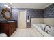 Powder room with granite vanity, floral wallpaper, and built-in tub at 1681 Long Bow Ln, Clearwater, FL 33764