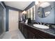 Bathroom features dual sinks with sleek black granite countertops under modern lighting at 1681 Long Bow Ln, Clearwater, FL 33764