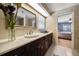 Elegant bathroom featuring a marble countertop, dark wood cabinets, and updated fixtures at 1681 Long Bow Ln, Clearwater, FL 33764