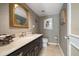 Charming powder room with ornate mirror and decorative wallpaper at 1681 Long Bow Ln, Clearwater, FL 33764