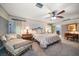 Spacious bedroom with elegant furnishings and a ceiling fan, offering a comfortable and inviting retreat at 1681 Long Bow Ln, Clearwater, FL 33764