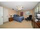 Cozy bedroom featuring a fan, natural light, and warm neutral walls at 1681 Long Bow Ln, Clearwater, FL 33764