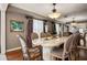 Formal dining room with an elegant chandelier, large table, and hardwood floors at 1681 Long Bow Ln, Clearwater, FL 33764