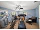 Bright exercise room with blue walls, ceiling fan, treadmill, stationary bike, and elliptical machine at 1681 Long Bow Ln, Clearwater, FL 33764