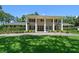Striking home with symmetrical design, prominent columns, manicured lawn, and inviting curb appeal at 1681 Long Bow Ln, Clearwater, FL 33764