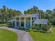 Stately two-story home with traditional architecture, a circular driveway, and manicured landscaping at 1681 Long Bow Ln, Clearwater, FL 33764